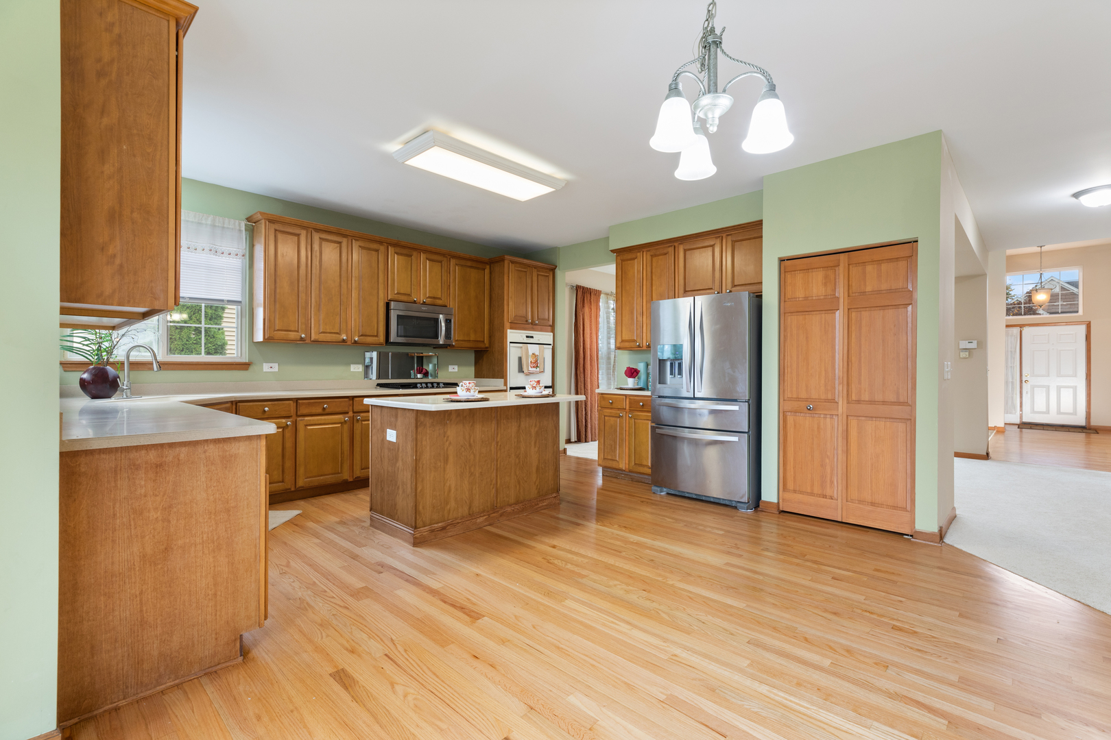 25231 Gettysburg Road Plainfield, IL 60544 - Photo 8 of 30 a kitchen with stainless steel appliances wooden floors and wooden cabinets