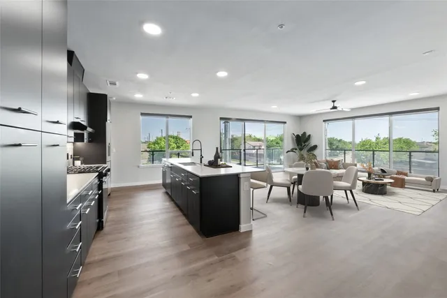 a view of a patio with couches table and chairs with wooden floor and plants