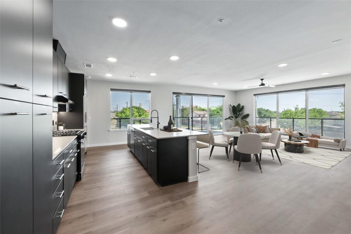 4510 Terry-O Lane, Unit 230 Austin, TX 78745 - Photo 37 of 39 a large living room with stainless steel appliances granite countertop a couch and a view of kitchen