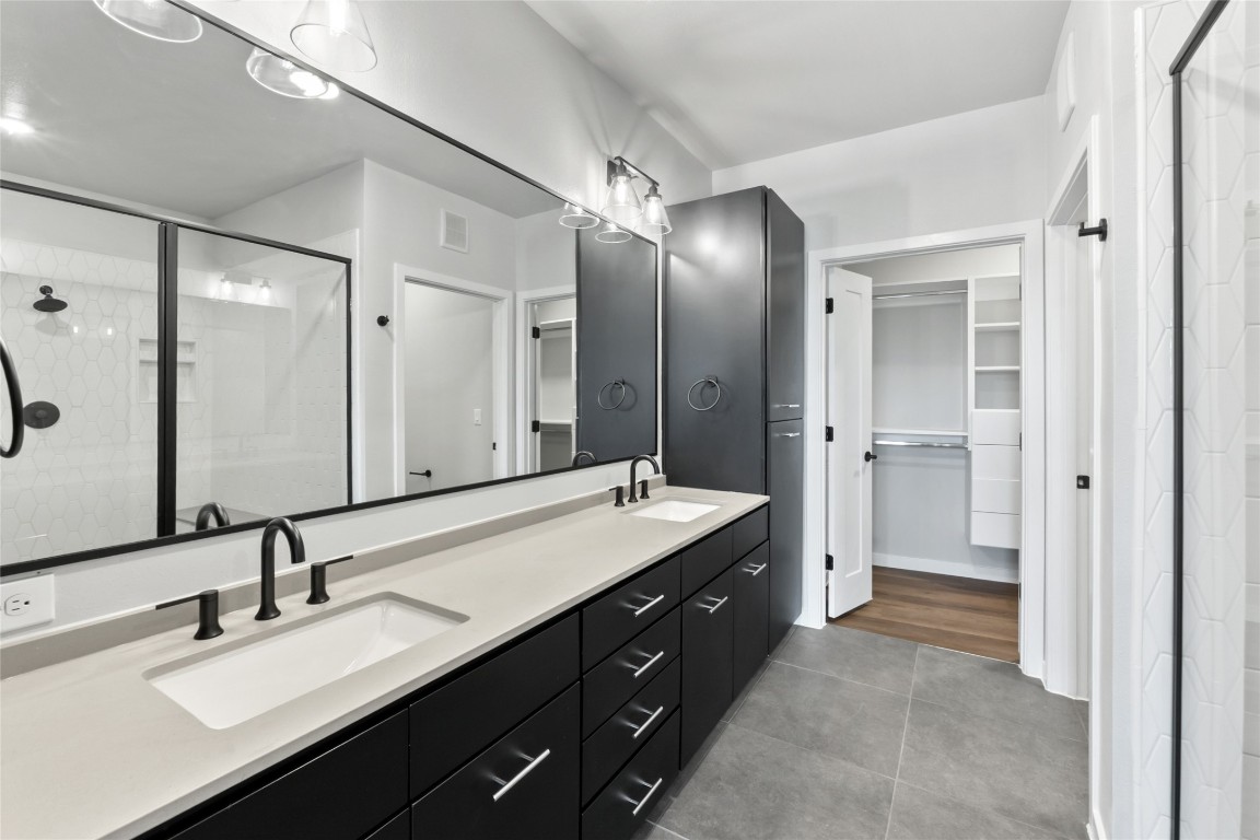 4510 Terry-O Lane, Unit 230 Austin, TX 78745 - Photo 9 of 39 a spacious bathroom with a double vanity sink mirror and double
