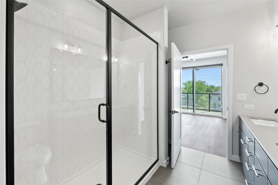 4510 Terry-O Lane, Unit 230 Austin, TX 78745 - Photo 15 of 39 a bathroom with a granite countertop sink a mirror and shower