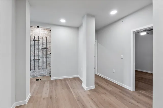 a bathroom with a granite countertop sink a mirror and shower