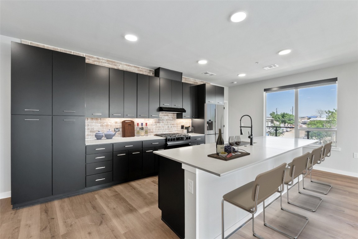4510 Terry-O Lane, Unit 230 Austin, TX 78745 - Photo 1 of 39 a kitchen with stainless steel appliances kitchen island granite countertop a sink and cabinets