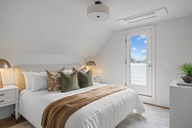 a bedroom with a bed and a potted plant