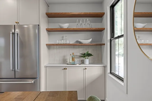 a kitchen with a refrigerator and cabinets