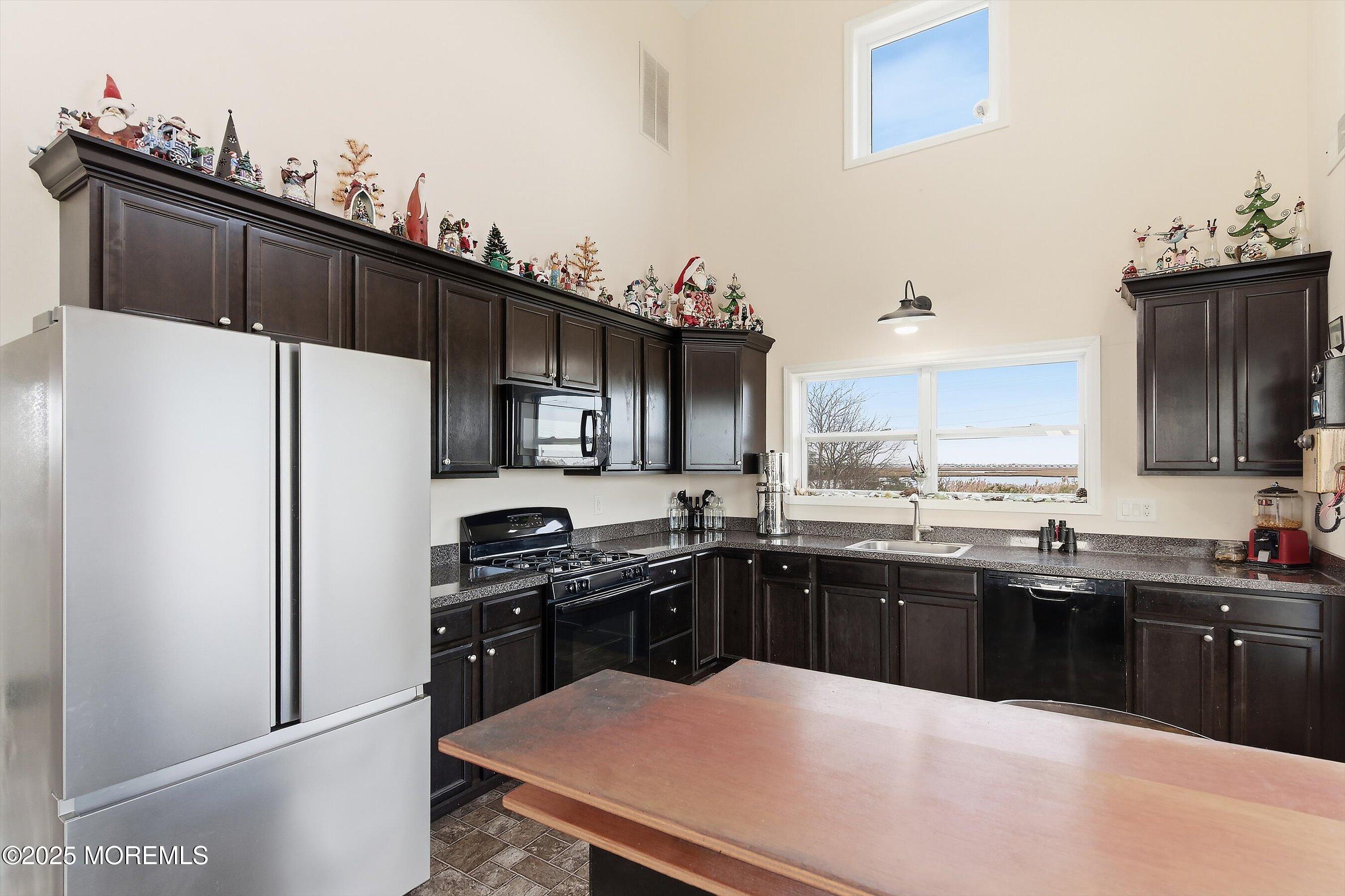 54 Beach Avenue Bayville, NJ 08721 - Photo 14 of 31 a kitchen with stainless steel appliances a sink stove refrigerator and cabinets