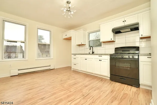 a kitchen with a stove a sink and a microwave