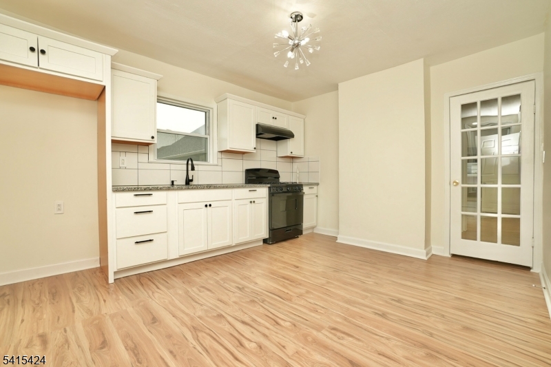 81 Berkeley Avenue Bloomfield, NJ 07003 - Photo 14 of 43 a view of a kitchen with wooden floor and a sink