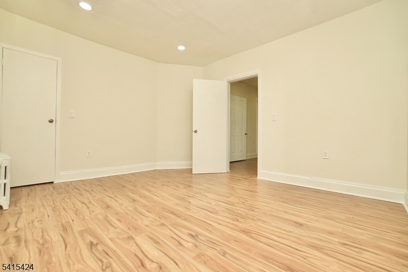 81 Berkeley Avenue Bloomfield, NJ 07003 - Photo 22 of 43 a view of an empty room with wooden floor