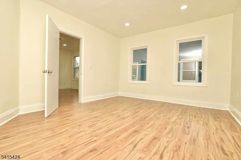 81 Berkeley Avenue Bloomfield, NJ 07003 - Photo 25 of 43 a view of empty room with wooden floor and fan