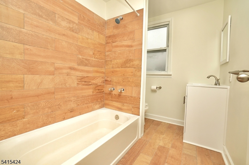 81 Berkeley Avenue Bloomfield, NJ 07003 - Photo 28 of 43 a bathroom with a bathtub and shower