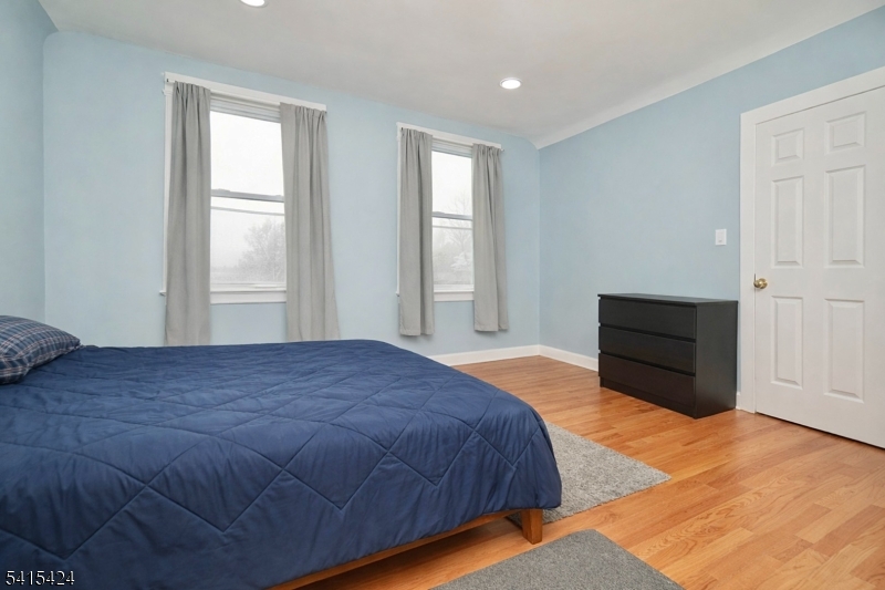 81 Berkeley Avenue Bloomfield, NJ 07003 - Photo 32 of 43 a bedroom with a bed and a window