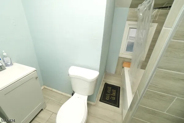 a white toilet sitting next to a sink and toilet