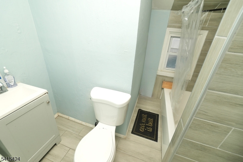 81 Berkeley Avenue Bloomfield, NJ 07003 - Photo 35 of 43 a white toilet sitting next to a sink and toilet