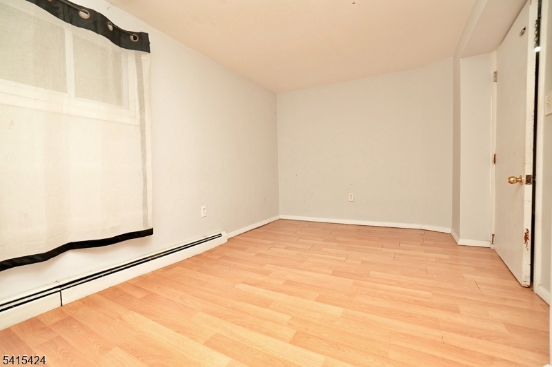 81 Berkeley Avenue Bloomfield, NJ 07003 - Photo 37 of 43 a view of empty room with wooden floor