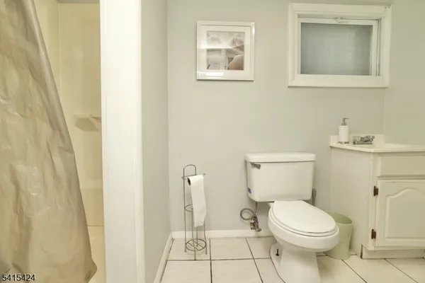 a white toilet sitting next to a bathroom sink
