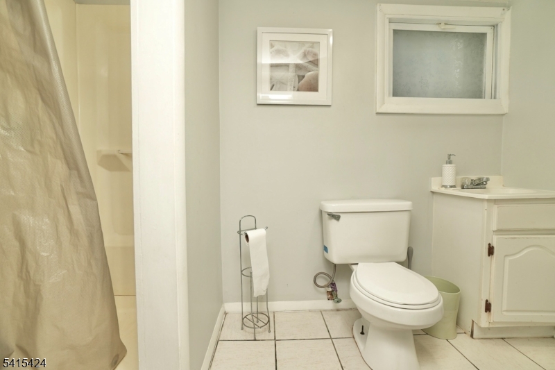 81 Berkeley Avenue Bloomfield, NJ 07003 - Photo 41 of 43 a white toilet sitting next to a bathroom sink