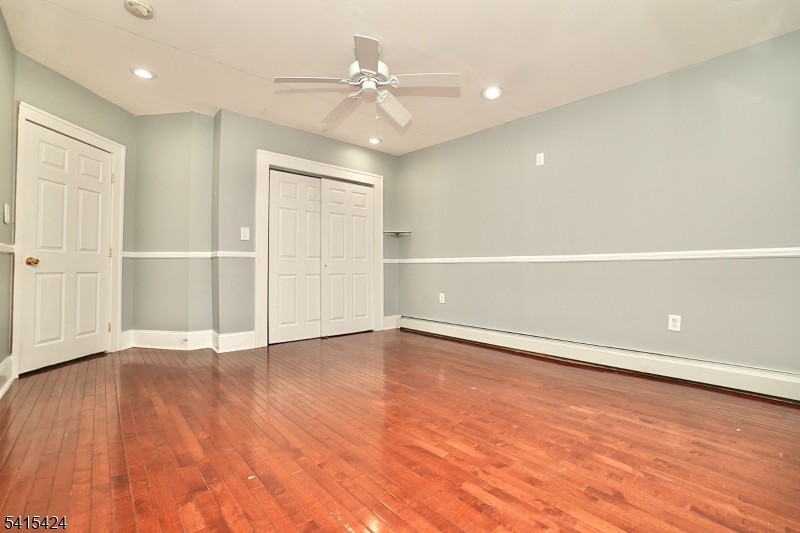 81 Berkeley Avenue Bloomfield, NJ 07003 - Photo 9 of 43 wooden floor in an empty room with a window