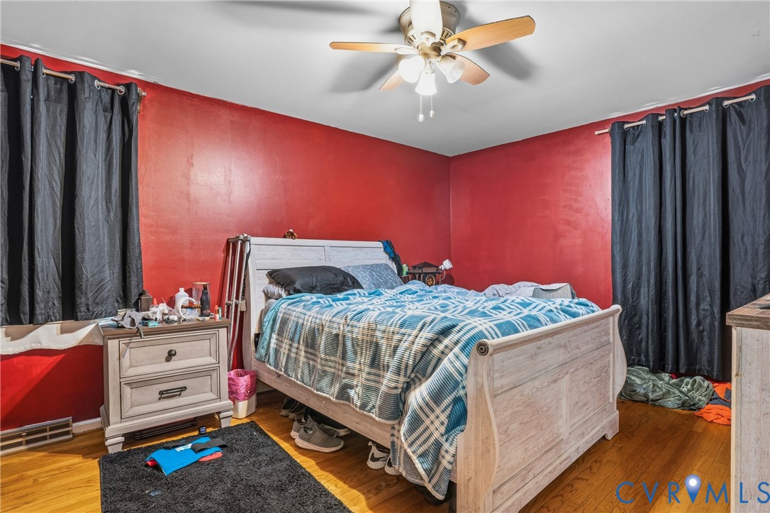 14219 Spruce Avenue Chester, VA 23836 - Photo 18 of 32 a bedroom with a bed and a chandelier