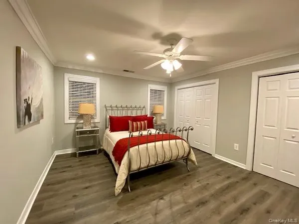a bedroom with a large bed a chandelier and closet