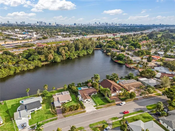 an aerial view of residential houses with outdoor space and lake view
