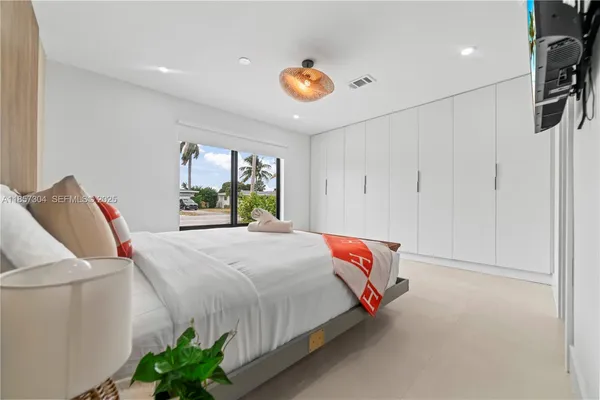 a bedroom with a bed and a couch