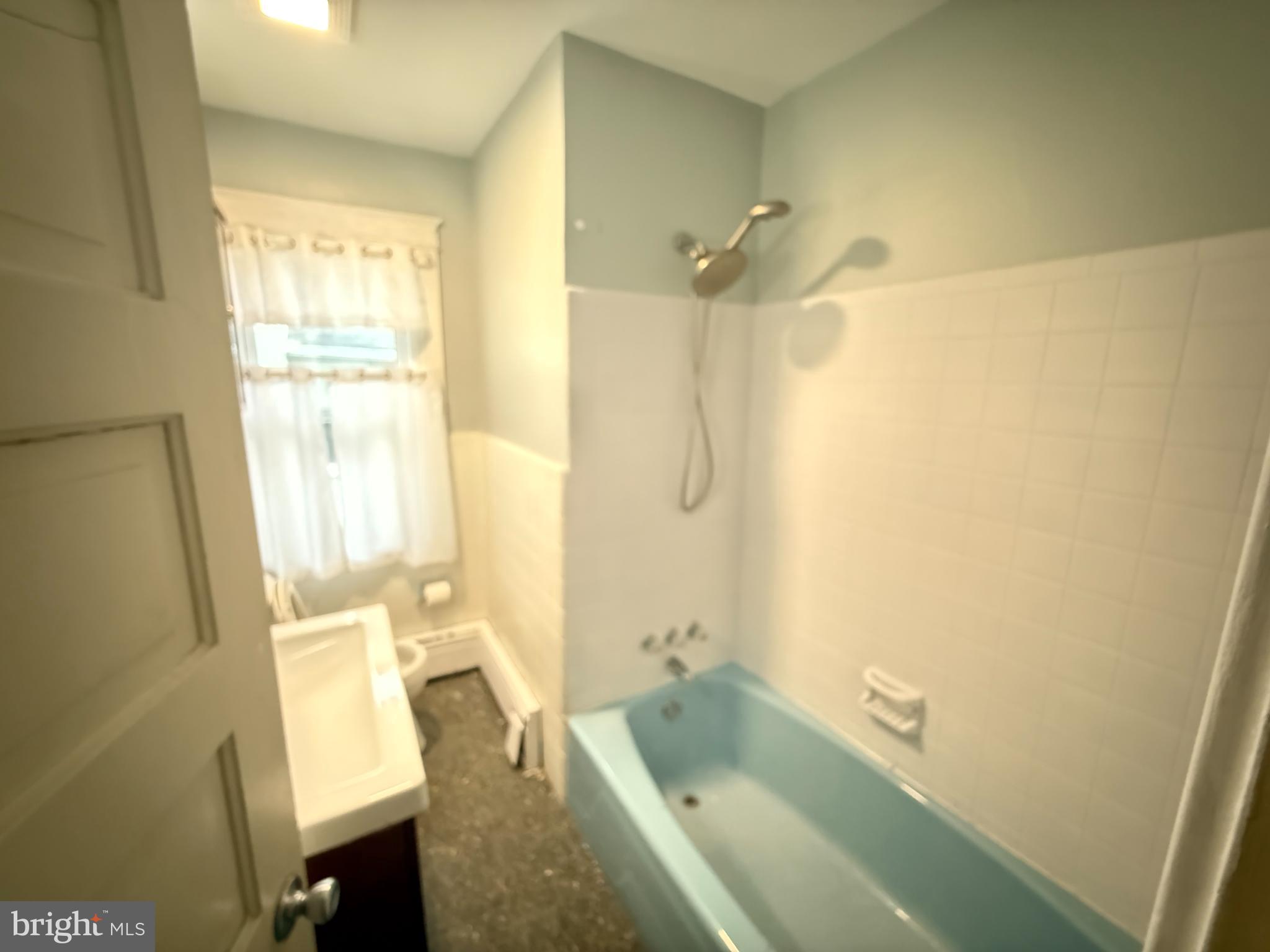 4049 Marshall Road Upper Darby, PA 19026 - Photo 19 of 26 a bathroom with a tub sink and a shower