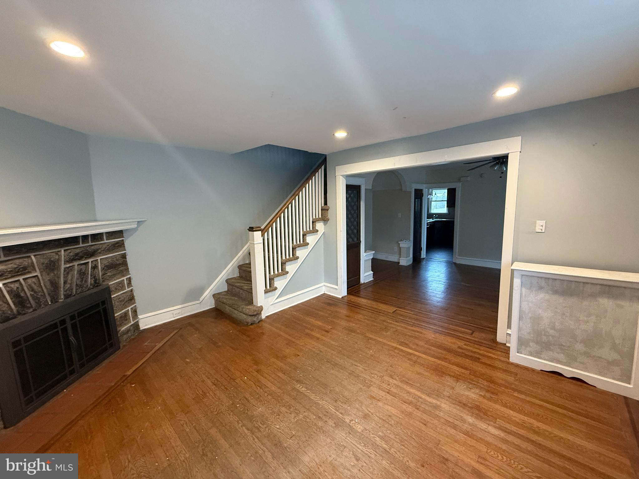 4049 Marshall Road Upper Darby, PA 19026 - Photo 5 of 26 a view of an empty room with wooden floor and a fireplace