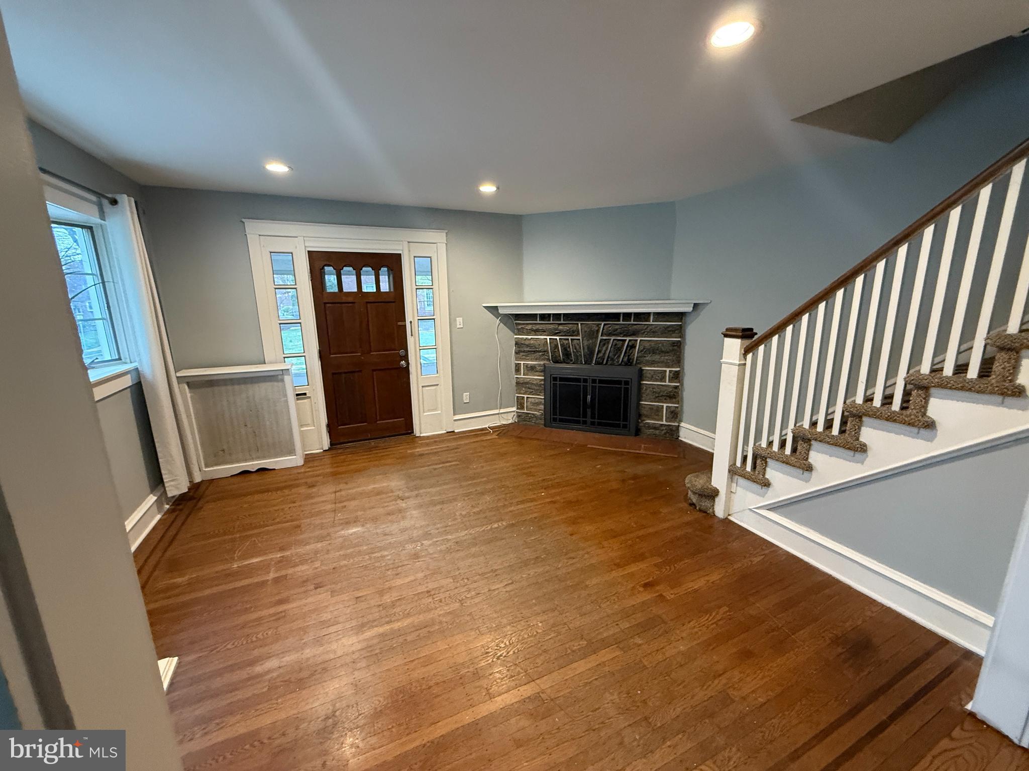 4049 Marshall Road Upper Darby, PA 19026 - Photo 6 of 26 an empty room with wooden floor and fireplace
