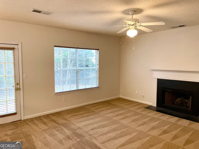 a view of a bedroom with wooden floor