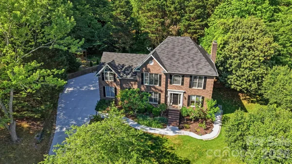 an aerial view of a house with garden space and sitting area