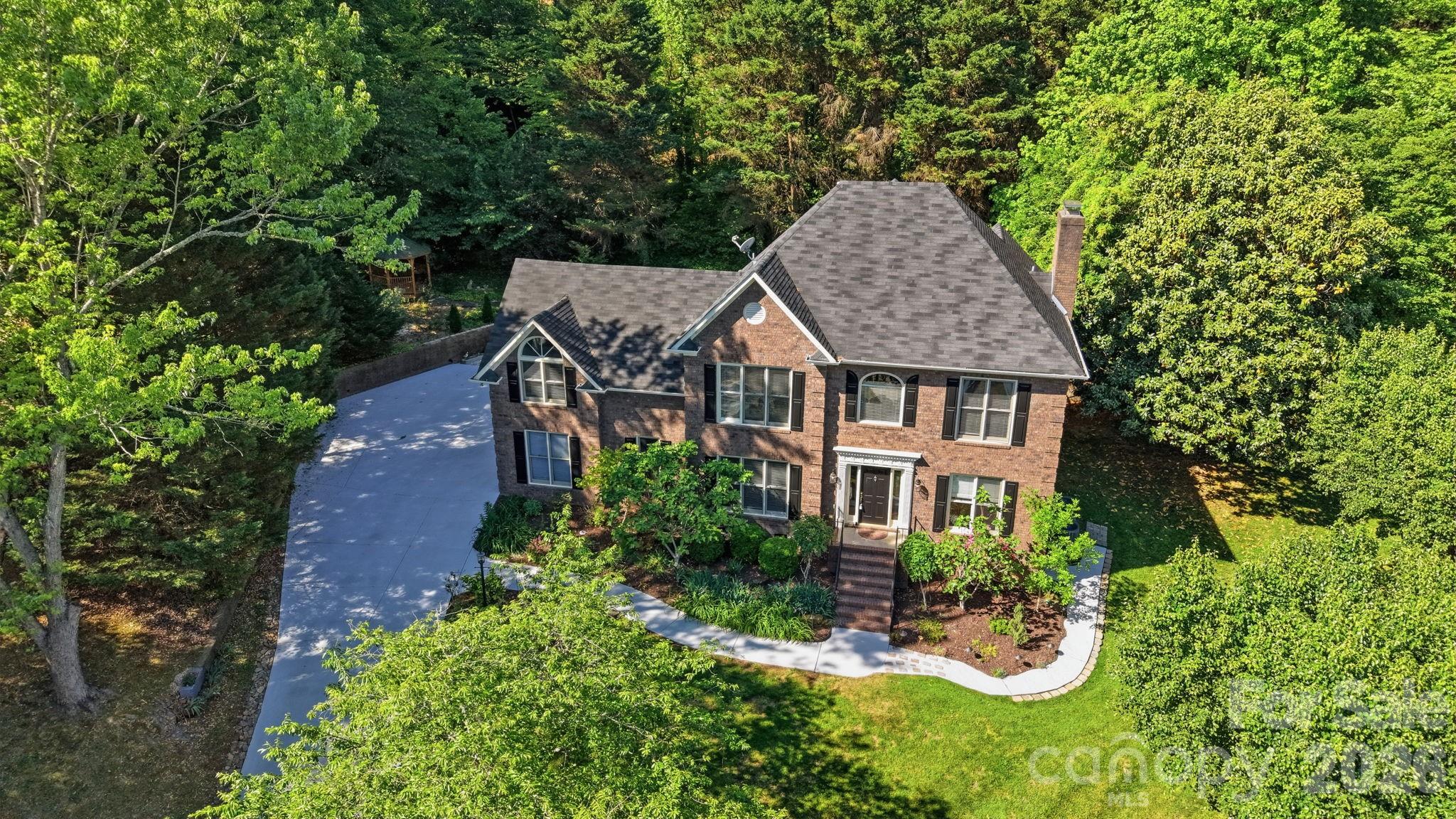 an aerial view of a house with garden space and sitting area