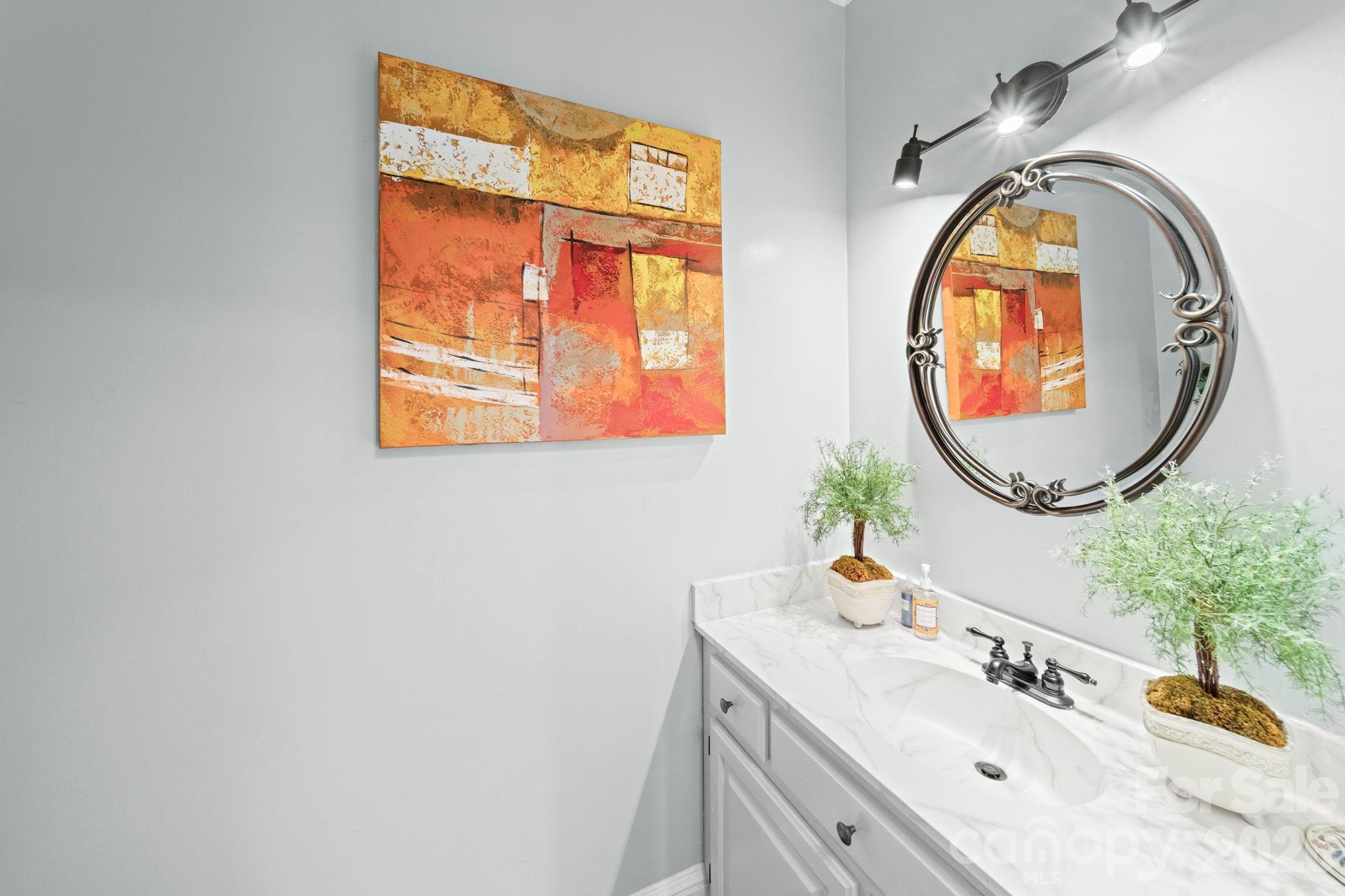 1265 Braeburn Road Northwest Concord, NC 28027 - Photo 15 of 48 a bathroom with a sink and a mirror