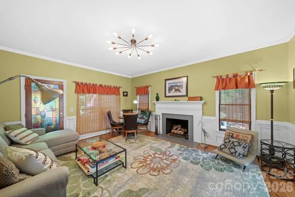 a living room with furniture a rug and a fireplace