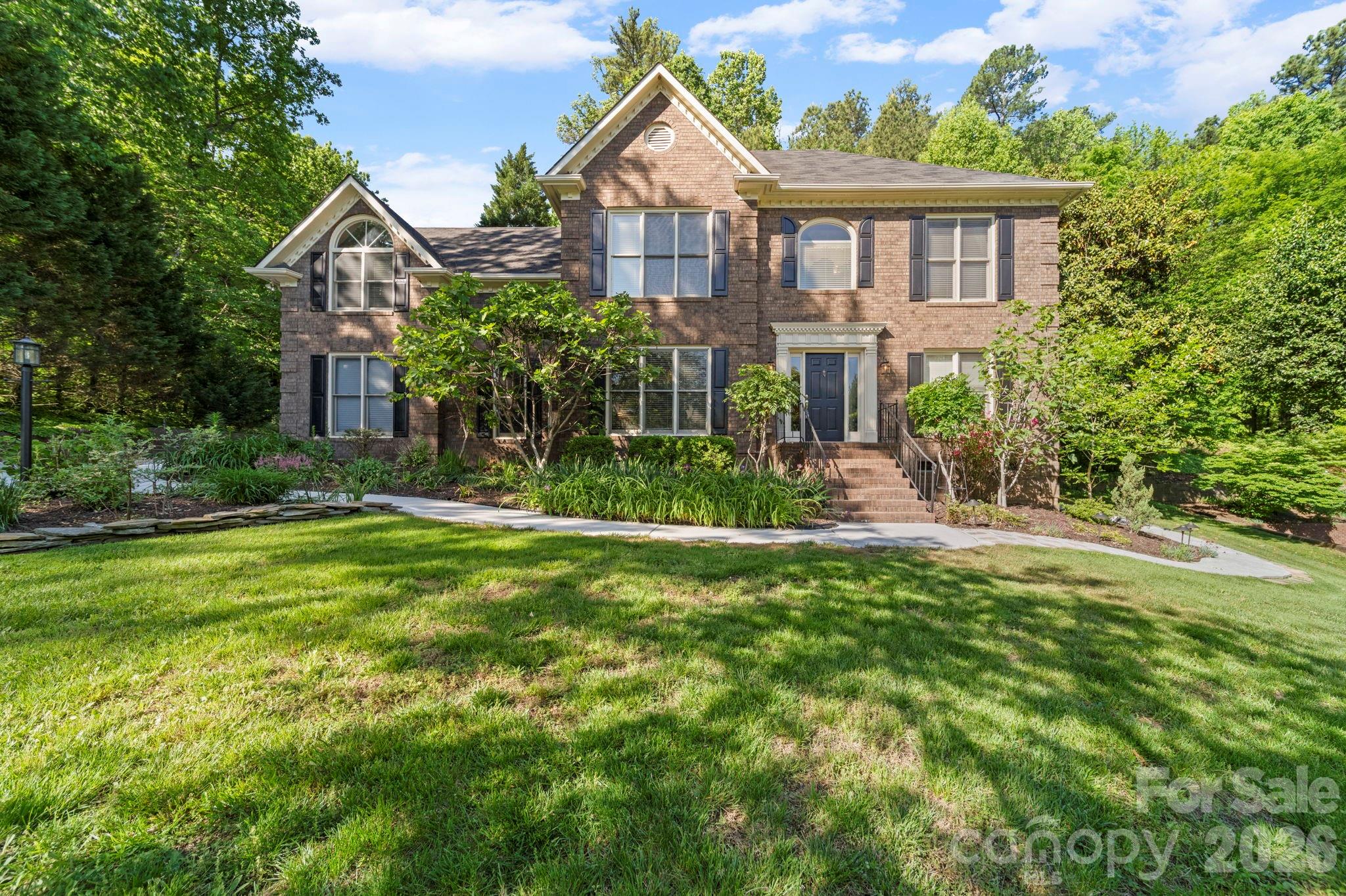 1265 Braeburn Road Northwest Concord, NC 28027 - Photo 2 of 48 a front view of a house with a garden