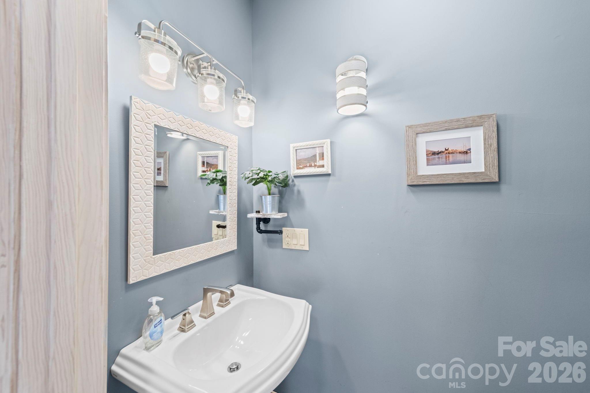 1265 Braeburn Road Northwest Concord, NC 28027 - Photo 22 of 48 a bathroom with a sink and a mirror