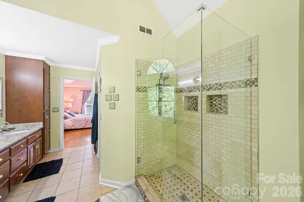 a bathroom with a glass shower door