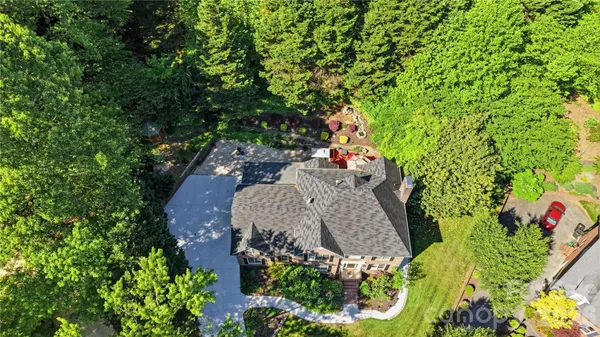 an aerial view of a house with yard and outdoor seating