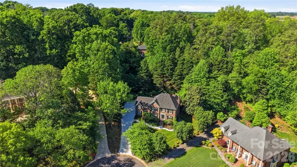 a aerial view of a house with a yard and lake view