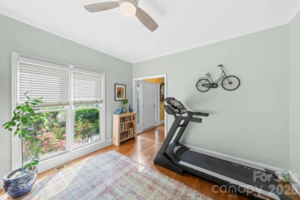 a room with gym equipment and large window