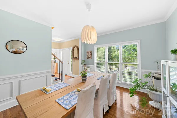 a view of a dining room with furniture wooden floor and a chandelier