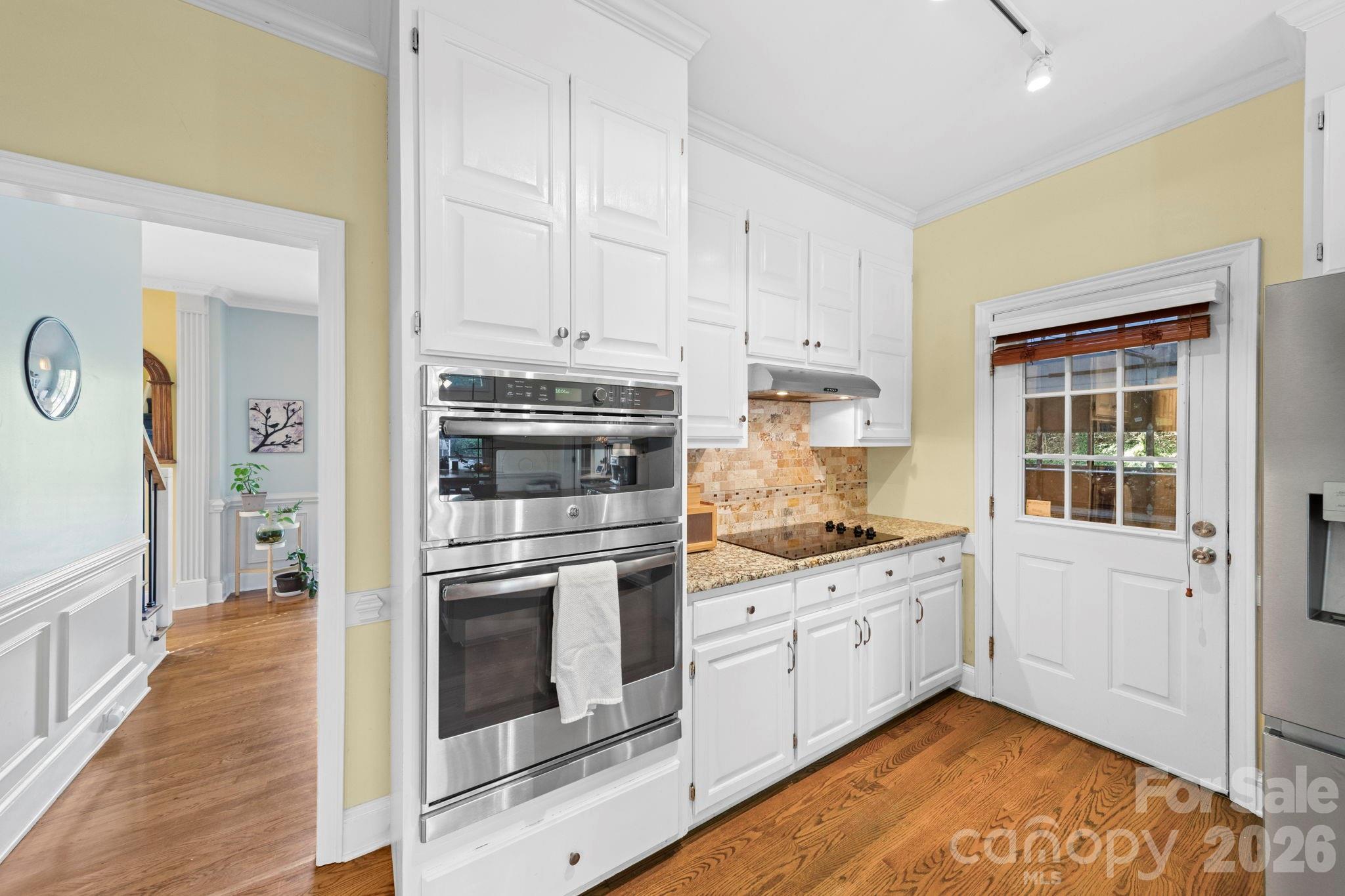 1265 Braeburn Road Northwest Concord, NC 28027 - Photo 9 of 48 a kitchen with granite countertop a stove and a sink
