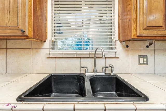 a kitchen with stainless steel appliances granite countertop a sink and cabinets