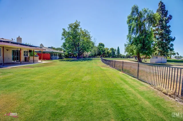 a view of a house with pool and a yard