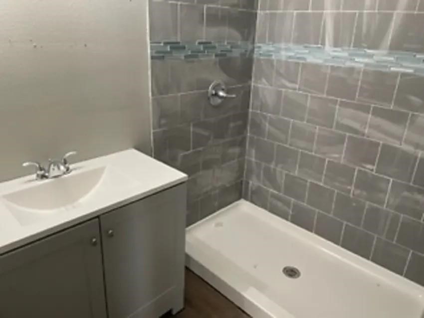 105 Dooley Street Prairie View, TX 77446 - Photo 6 of 8 a bathroom with a sink and a bathtub