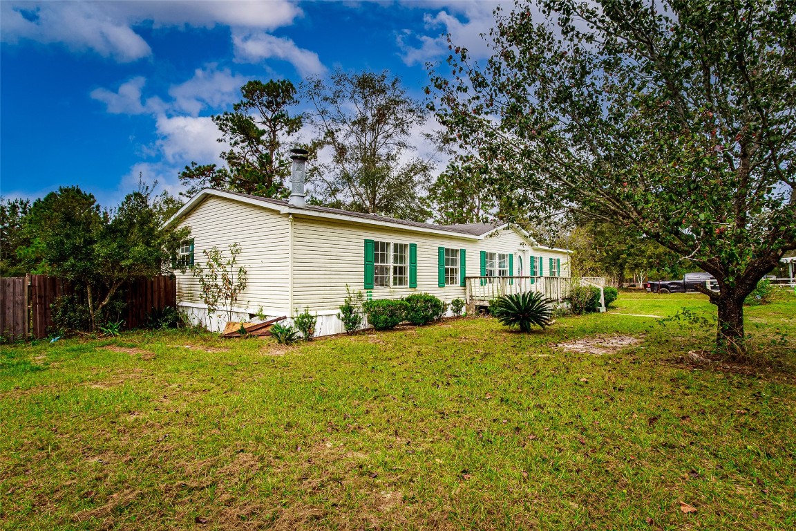 18044 Geranium Lane Hilliard, FL 32046 - Photo 14 of 15 a view of a house with backyard and sitting area