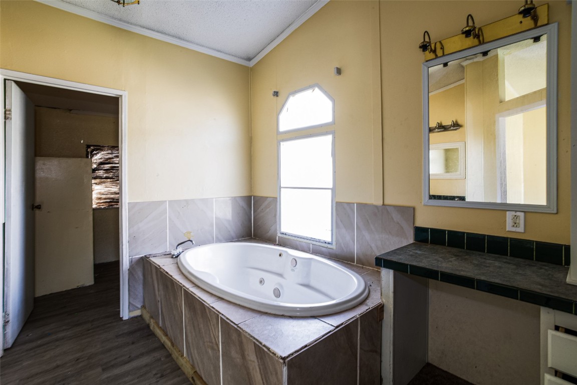 18044 Geranium Lane Hilliard, FL 32046 - Photo 6 of 15 a bathroom with a granite countertop sink and a mirror