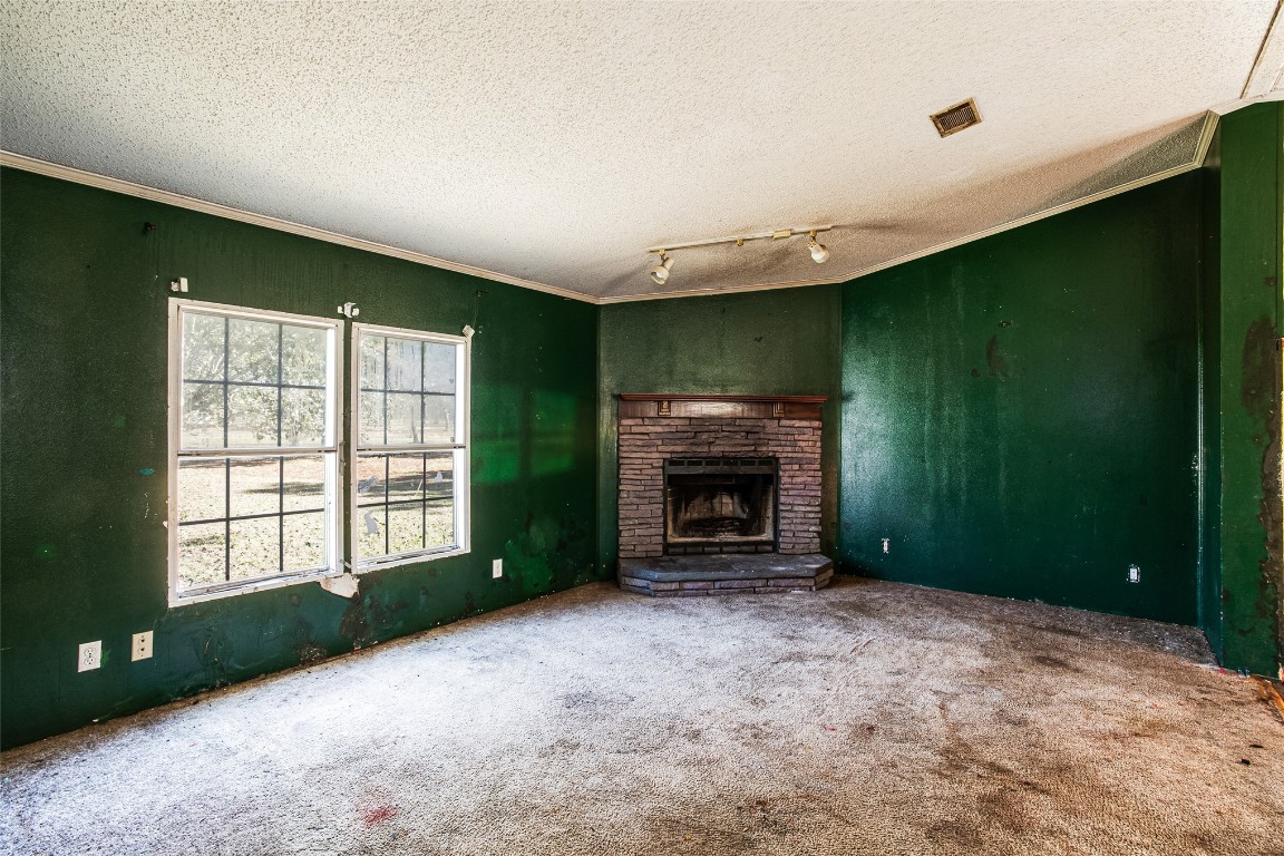 18044 Geranium Lane Hilliard, FL 32046 - Photo 9 of 15 an empty room with windows and fireplace