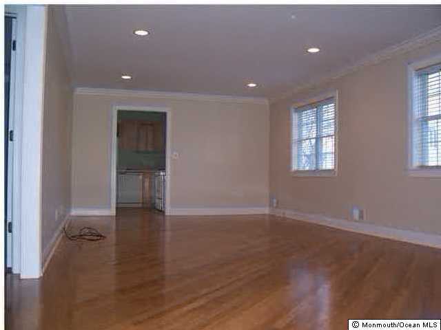 33 Rivington Avenue West Long Branch, NJ 07764 - Photo 3 of 3 an empty room with wooden floor and windows