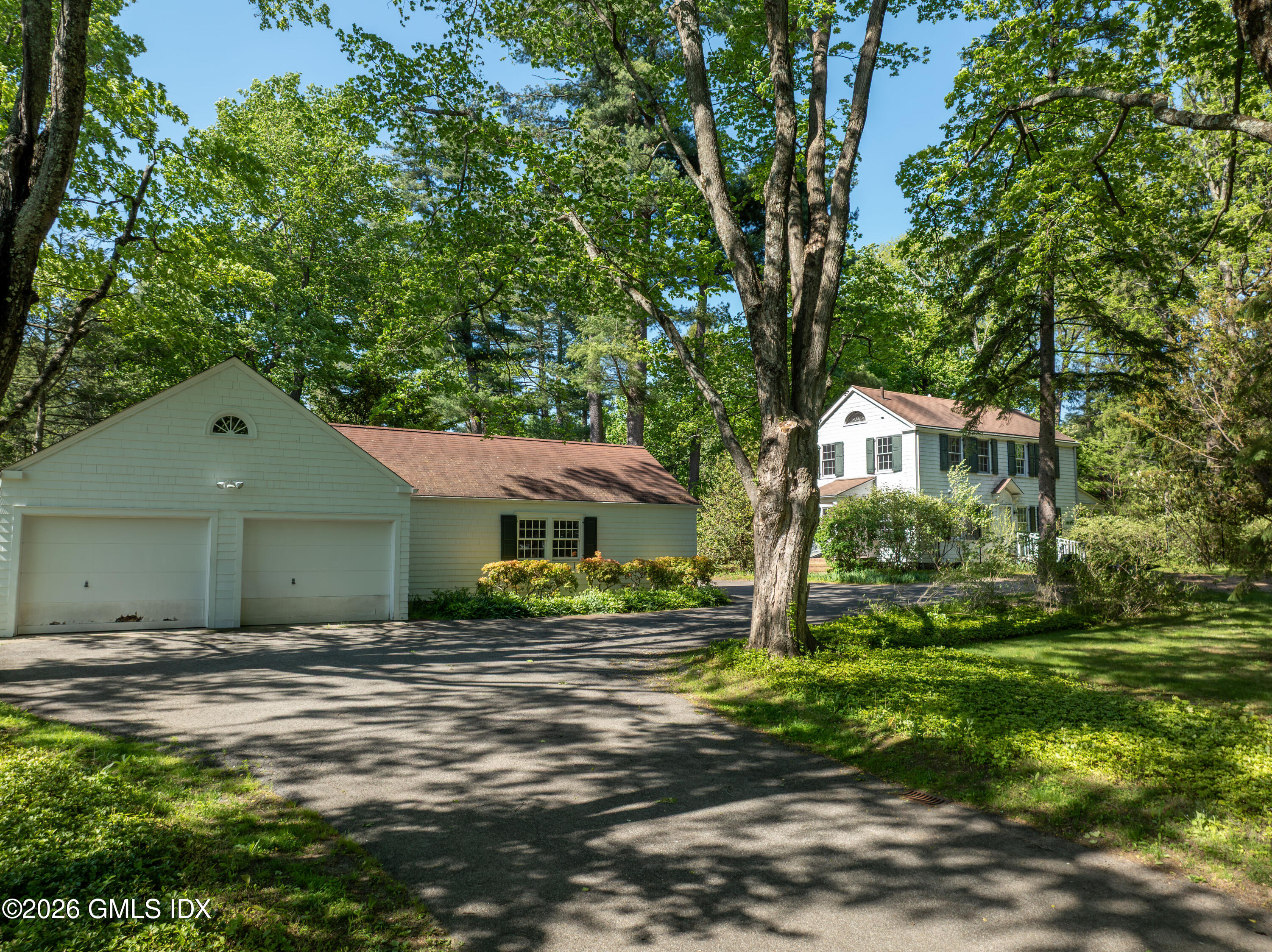 122 Round Hill Road Greenwich, CT 06831 - Photo 35 of 37 a front view of a house with garden